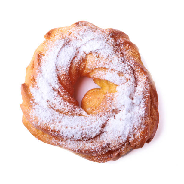 istock Chocolate and powdered sugar cream puff rings, choux pastry. Isolated on white background. 1127871719