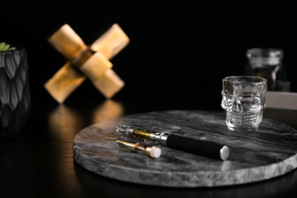 Marijuana Vape Pen and Concentrate on Dark Marble Luxury Cannabis stock photo