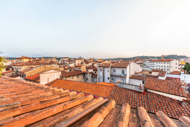 istock Firenze, Florence, Italy historic city with rooftop tile architecture during summer evening sunset cityscape skyline high angle aerial view of urban roofs 1127872600
