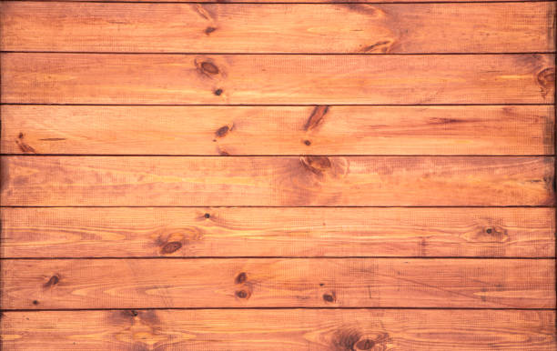 istock closeup background of orange wood old texture 1127873773