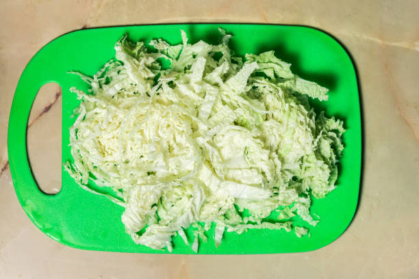istock Sliced Chinese cabbage on a green board for the whole frame 1127874834
