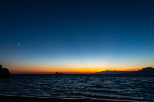sunset with a dark blue sky turning into bright orange at the south of Crete