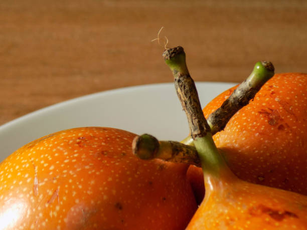 trio The composition features three of these fruits intertwined by their branches. tres objetos stock pictures, royalty-free photos & images