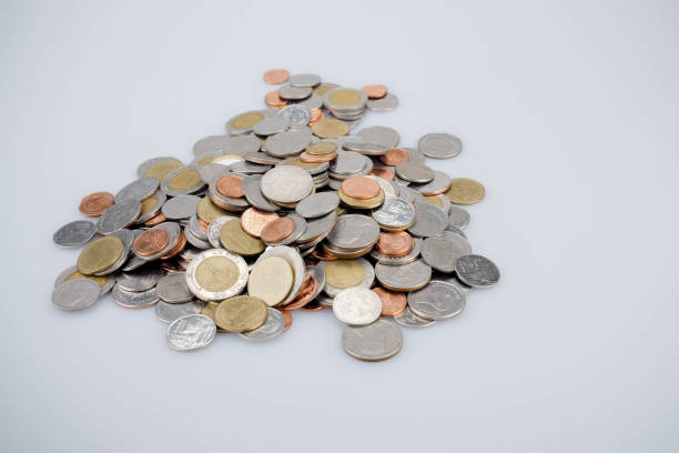 istock Close-Up Of Coins Against White Background 1127879095
