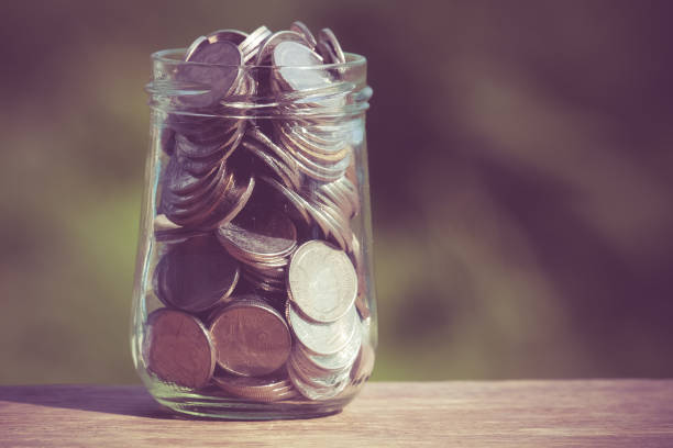 istock Close-Up Of Coins In Jar On Table 1127880547