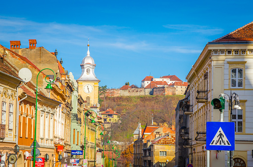 Tourists walk along beautiful street of old town Brasov, Romania