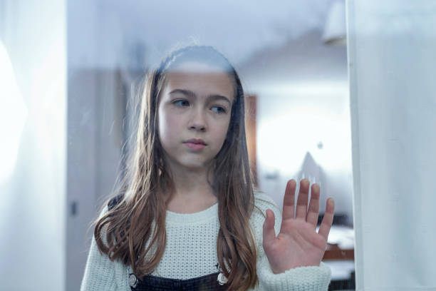 istock Lonely Child Near the Window 1127883286