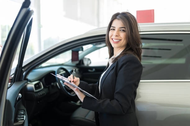 istock Woman Working At Car Dealership 1127883569