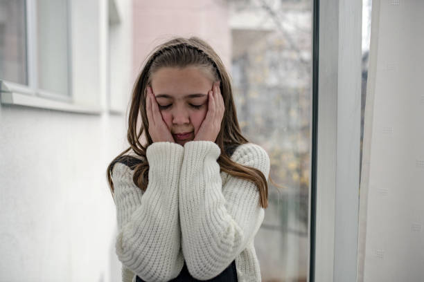 istock Lonely Child with Headache Near the Window 1127883647