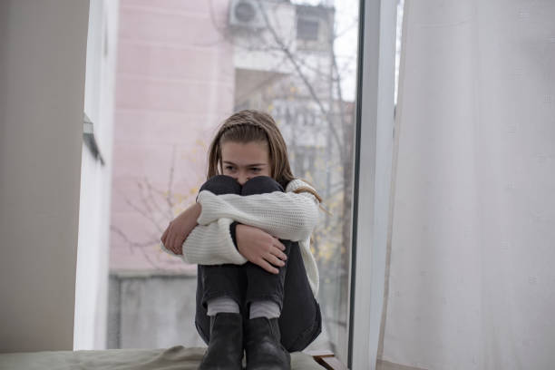 istock Lonely Child with Headache Near the Window 1127883655
