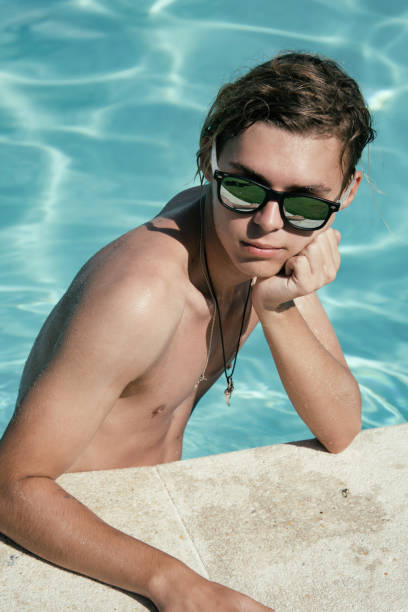 istock Young attractive guy. Summer, relaxation and pool. 1127884810