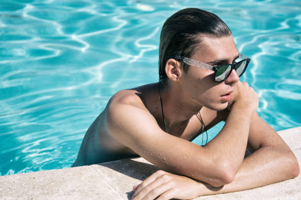 istock Young attractive guy. Summer, relaxation and pool. 1127885334
