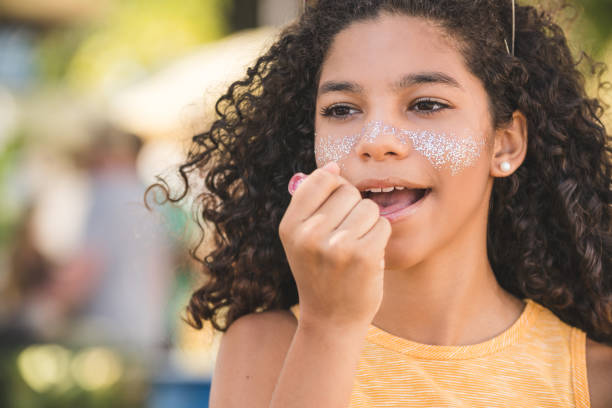 istock Girl applying lipstick 1127887083