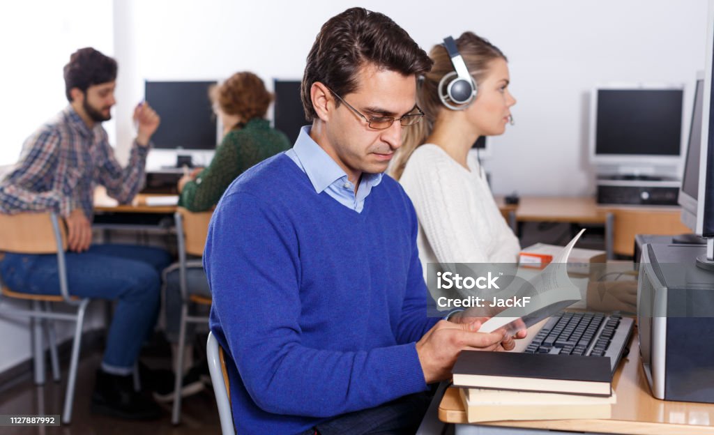 Reading Computing Serious Student Reading Textbooks In Computer Class Stock Photo ...