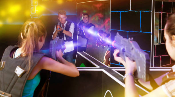 istock Excited people playing enthusiastically laser tag game 1127888023
