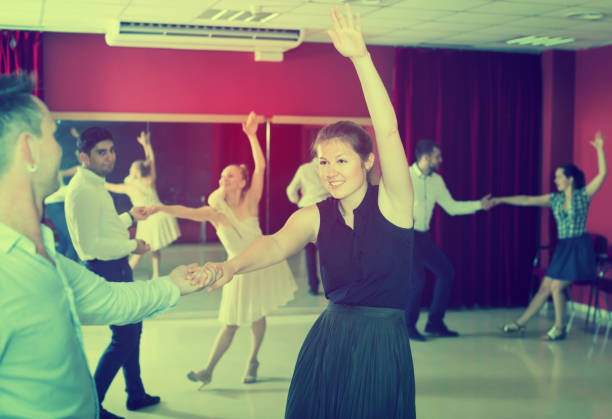 istock Friendly group people dancing lindy hop in pairs 1127888069