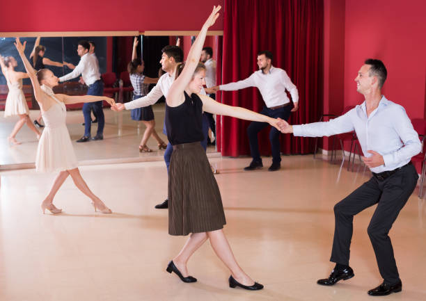 istock Joyful people dancing lindy hop in pairs 1127888075