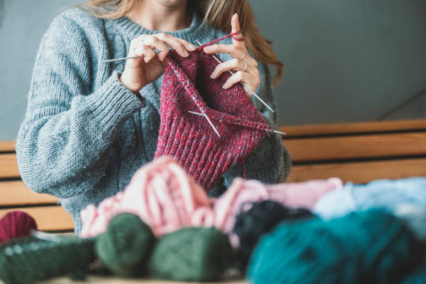 istock Close up on woman's hands knitting 1127888982