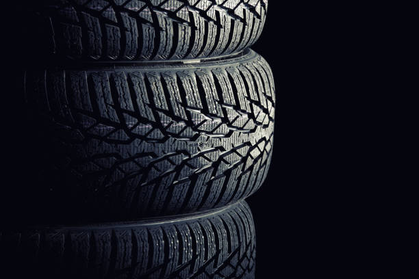 istock Close-Up Of Tires On Black Background 1127890020