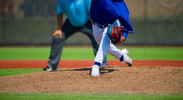 istock Low Section View Of Baseball Players Standing On Playing Field 1127891033