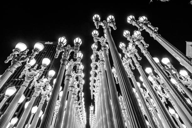 Los Angeles, California, United States - August 9, 2018: view of Urban Light at night, sculpture by Chris Burden at LA Contemporary Art Museum LACMA, with 202 street lamps. Black and white shot.