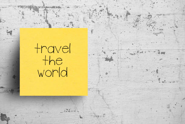 istock Sticky note on concrete wall, Travel the world 1127896341