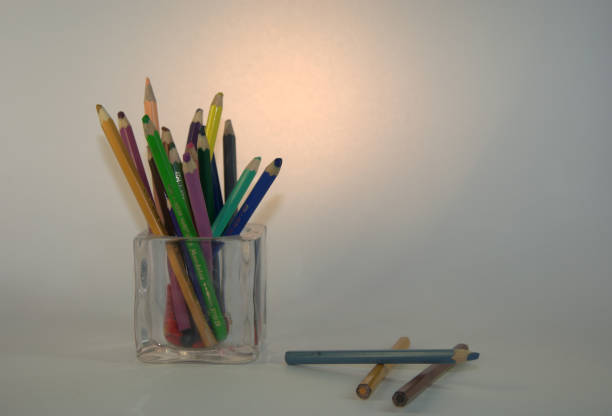 istock Multicolored pencils in a transparent stand. A picture on a white background. 1127898995