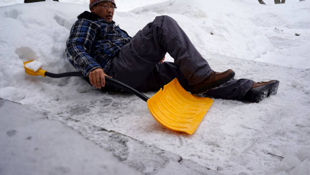 istock Man fell with snow shovel 1127899187