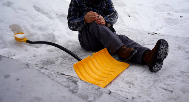 istock Man fell with snow shovel 1127899733