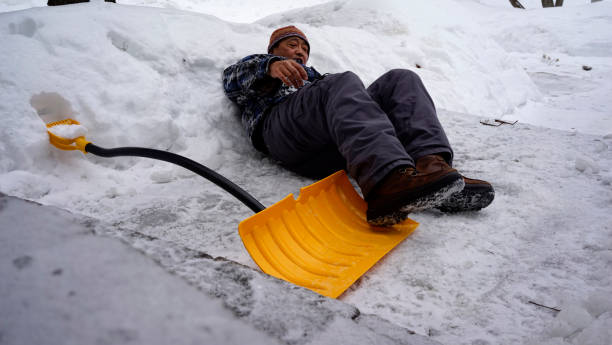 istock Man fell with snow shovel 1127899748