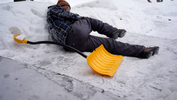 istock Man fell with snow shovel 1127899820