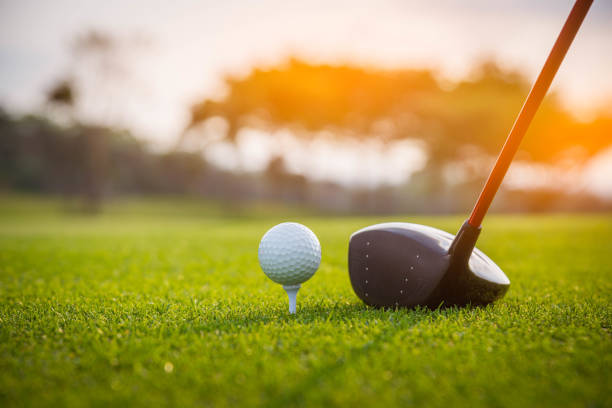 istock Golfer is putting golf ball on green grass at golf course for game with blur background and sunlight ray. 1127900793