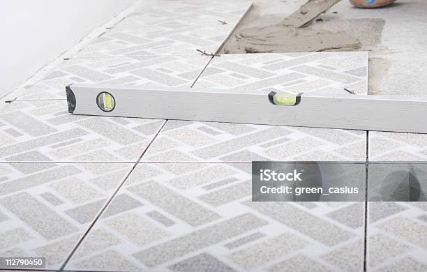 Using Level Ruler Stock Photo - Download Image Now - Tile, Level - Measurement Tool, Flooring