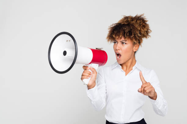 istock Female protestor making an announcement with megaphone 1127908691