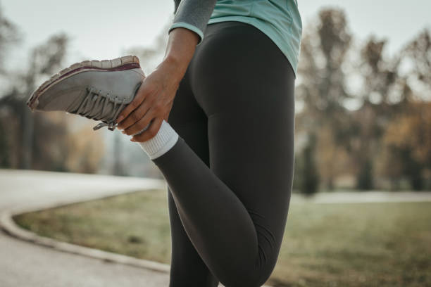 istock Female athlete stretching in the park 1127908722