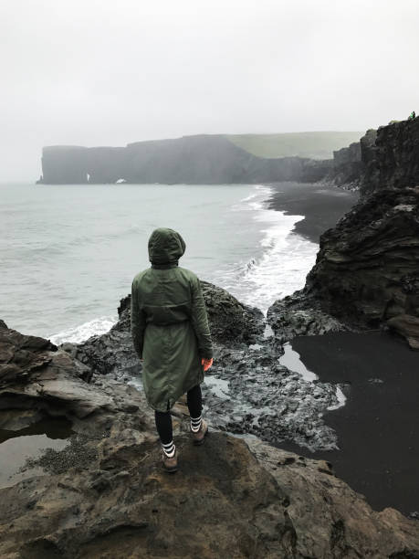 istock Wanderlust explorer discovering icelandic natural wonders. Basalt rock on black sand beach as known as Reynisfjara beach in the south coast of Iceland in fog and cloudy day. 1127908893