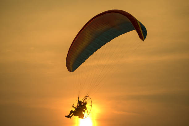 istock Silhouette picture of the Paramotors flying 1127909624
