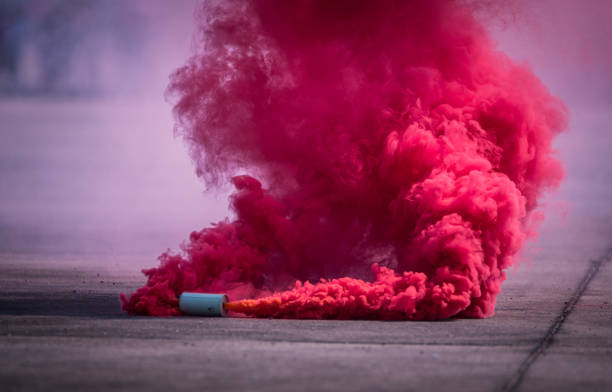 istock Colorful pink smoke bombs action in showing 1127909666