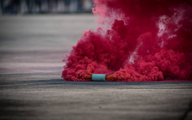 istock Colorful pink smoke bombs action in showing 1127909731