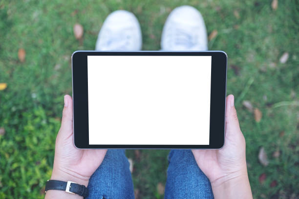 istock a woman holding and using black tablet pc with blank white desktop screen 1127915077