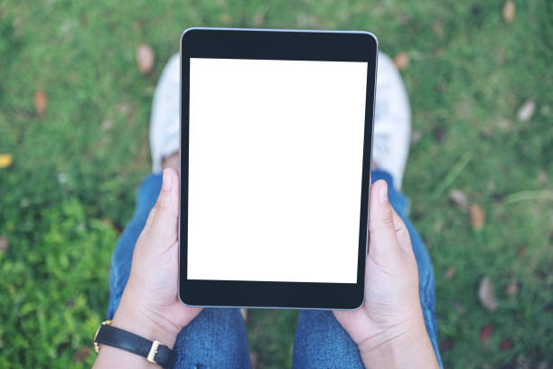 istock a woman holding and using black tablet pc with blank white desktop screen 1127915122