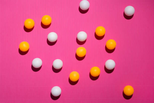 istock White and orange balls on a pink background 1127915991