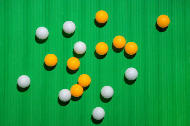 istock White and orange balls on a green background 1127916160