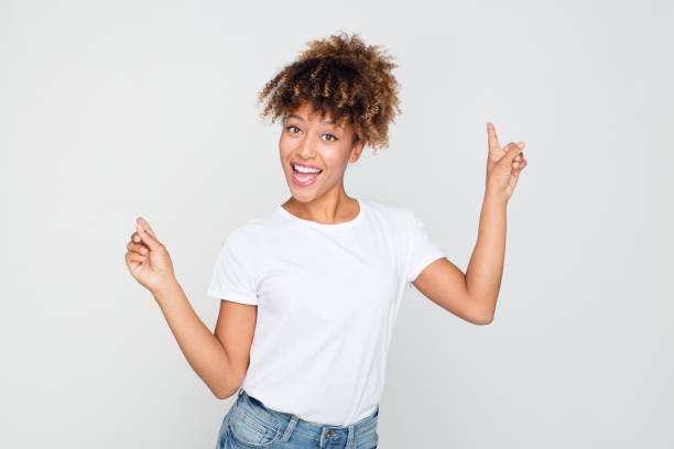istock Excited woman pointing at blank copy space 1127918091