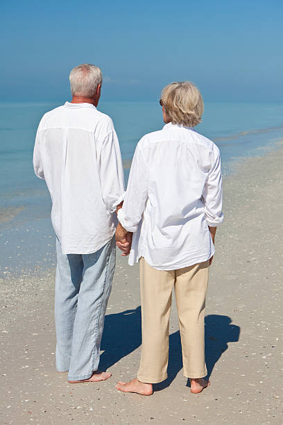 istock Happy Senior Couple Holdings Hands on A Tropical Beach 112791862