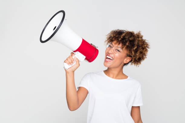 istock Woman making an announcement with megaphone 1127919330