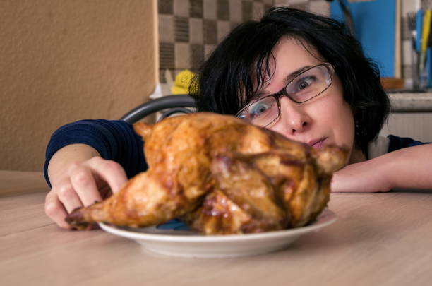 istock Woman Looking At Roasted Chicken In Kitchen At Home 1127919546