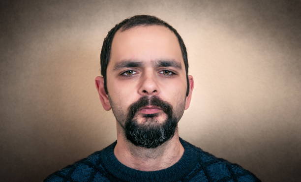 istock Close-Up Portrait Of Man Against Wall 1127919556