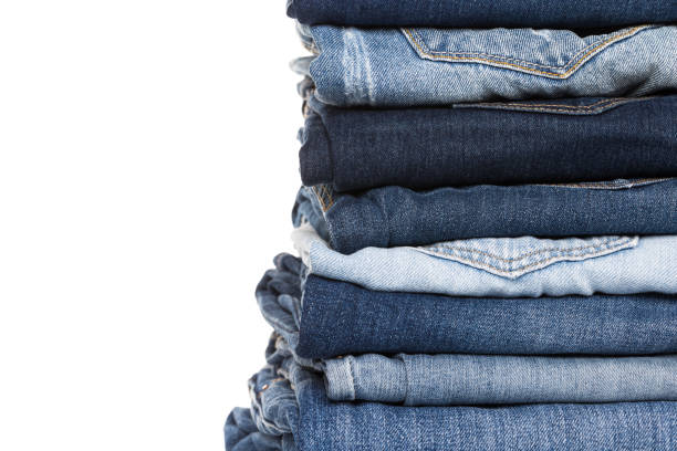 istock stack of various shades of blue jeans on white background 1127923929