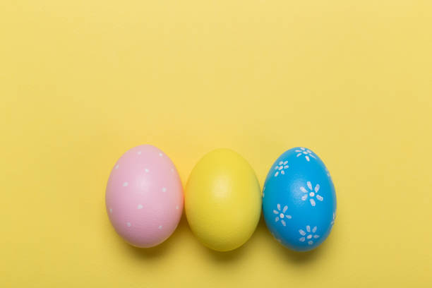 istock easter eggs on yellow pastel color background with space. Concept 1127923998